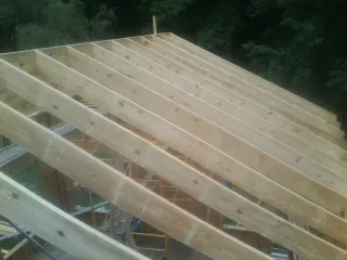 New roof rafters set over an addition before sheathing in Pulaski